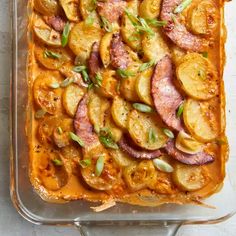 a casserole dish with sausage, potatoes and onions