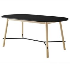 an oval table with black top and wooden legs