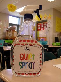 a bottle of quiet spray sitting on top of a table in front of a classroom