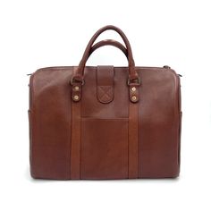 Elevate your carry-on with our newest bag the Travel Duffle. A bag that gets you anywhere you need to go, from the conference room to a weekend retreat, packing everything you need in style. Handcrafted in full-grain leather with antique brass hardware and storage compartments both inside and out. Complete with zipper closure, top strap buckle accent, smooth and sturdy handles, and removable crossbody strap. Details Double top handles Adjustable 54" crossbody strap Zipper and front clasp closure Classic Leather Travel Bag For Trips, Classic Leather Weekender Bag For Trips, Leather Trim Satchel For Business Trips, Luxury Cognac Satchel For Travel, Leather Lined Tote Laptop Bag For Travel, Classic Travel Bag With Leather Lining, Classic Tote Travel Bag For Business Trips, Classic Satchel Luggage For Everyday Use, Cognac Tote Weekender Bag For Travel