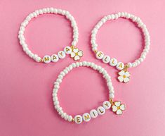 If you are looking for great quality and affordable 'Will you be my Flower Girl' proposal gifts, our personalized name beaded bracelets with flower charms, proposal cards and sweet gift boxes is the perfect choice! Make your little bridesmaids feel like princesses in your wedding day with these personalized bracelets without breaking the bank!  ♥ This dainty bracelet is perfect gift for your flower girls, jr bridesmaids or bridesmaids ! MATERIALS: ♥ 4 mm pearlised glass seed beads ♥ 6 mm gold letter beads ♥ round 14K gold pleated accent beads and flower charm. ♥  Our bracelet is packed in a gift box wrapped in organza ribbon and a special proposal card , ready to gift ! (if you choose box option).  "Bracelet Only" will not come with box. 🎁If you choose 'Bracelet Only ' option; your unboxe Personalized Flower Jewelry For Friendship, Personalized Flower-shaped Jewelry For Friendship, Personalized Flower Shaped Friendship Jewelry, Personalized Flower-shaped Friendship Jewelry, White Name Bracelet For Mother's Day Personalized Gift, Personalized White Name Bracelet For Mother's Day, Customizable Beaded Bracelets As Gift, Personalized White Charm Bracelet For Birthday, Adjustable White Name Charm Bracelet