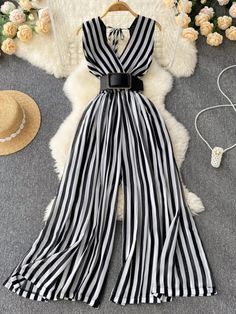 Black and White Striped Wide Leg Jumpsuit Elegant V-neck Jumpsuit For Beach, Elegant Vacation Jumpsuits And Rompers With V-neck, Elegant V-neck Jumpsuits And Rompers For Vacation, Elegant V-neck Jumpsuits And Rompers For Beach, Elegant V-neck Jumpsuit For Vacation, Black V-neck Jumpsuits For Summer, Chic One-piece Jumpsuits And Rompers For Vacation, Chic White Beach Jumpsuit Or Romper, Chic White Jumpsuit For The Beach