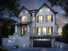 a large white house with lots of windows and lights on it's front porch