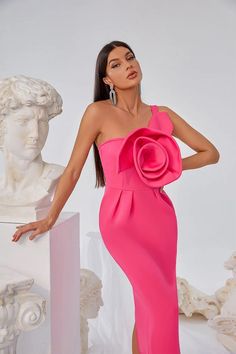 a woman in a pink dress posing for the camera