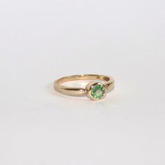 This ring has undergone a transformation. It started off a solid 9ct gold ring but it was set with a white CZ (CZ's are worth no more than a few pence each) I feel as though 9ct gold deserves to be set with something truly special. I sourced this gorgeous 4.5mm sage green sapphire to be encased in this metal. This piece really has a piece of my heart and I can't wait to see it be worn by someone who loves it just as much. It is a size N and weighs 1.72g and it is fully hallmarked. Heirloom Diamond Ring With Birthstone In Round Cut, Classic Solitaire Diamond Ring For May Birthstone, Classic Brilliant Cut May Birthstone Ring, Solitaire Ring For Promise And May Birthstone, Solitaire Promise Ring For May Birthstone, Heirloom Style Solitaire Rings For May Birthstone, Classic Green 14k Gold Stackable Rings, Solitaire Ring For May Birthstone In Fine Jewelry Style, Fine Jewelry Solitaire Ring For May Birthstone