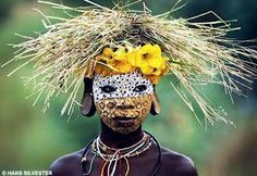 an african woman with flowers on her head