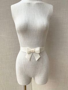 This super elegant delicate bridal belt is beautifully hand made out of silk organza. It features center bow detail with the hanging tails. The belt is finished in the back with the hidden clasp. Available in white, off white or ivory, please see the last photo for the color reference. This belt measures 1 1/4" wide and the length is finished to your measurements. Shown in the photos in ivory. We can make this belt in any other color if needed, please inquire about the custom order. * Please inc Elegant Adjustable Sashes For Formal Occasions, Elegant Adjustable Sash For Formal Occasions, Elegant Formal Adjustable Sash, Elegant Formal Adjustable Sashes, Formal Adjustable Bridal Belt With Sashes, Elegant Ribbon Bridal Belt For Wedding, Elegant Fitted Sash With Bow, Elegant Bridal Accessories With Satin Bow, Elegant Cream Satin Bow