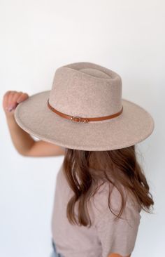 This wool wide brim hat with two interchangeable belts is the perfect addition to your wardrobe. Crafted from a wool blend, this stylish and timeless hat will elevate your look and give you a distinguished flair. Included with each hat are two belt color options: brown or black 10% wool, 90% polyester Beige Wide Brim Boater Hat For Fall, Beige Wide Brim Felt Hat, Beige Wide Brim Fedora For Winter, Chic Everyday Felt Hat For Winter, Chic Everyday Felt Hat For Fall, Chic Adjustable Wool Hat Band, Chic Wool Hat Bands For Fall, Chic Wool Hat Band For Fall, Chic Adjustable Wool Hat