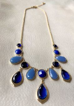 "This stunning gold, dark blue and light blue jeweled statement necklace is adorned with several teardrop and circular blue jewels accented by a beautiful gold chain. Necklace has a 3\" built in extender, lobster claw clasp, and finishing bead. This would make a gorgeous gift or can compliment any outfit easily. Approximate length, about: 20\" / Statement Necklace 》 P A C K A G I N G 《 Your jewelry will be nicely packaged. If one or more items are gifts, please leave a note at checkout and we'll Blue Jeweled Necklace For Party, Blue Jeweled Necklaces For Party, Blue Jewel Necklaces For Parties, Blue Jeweled Party Necklaces, Blue Teardrop Pendant Jewelry For Party, Blue Teardrop Pendant Necklace With Adjustable Chain, Blue Teardrop Necklace With Adjustable Chain, Blue Teardrop Drop Necklace For Party, Blue Dangle Necklaces For Party