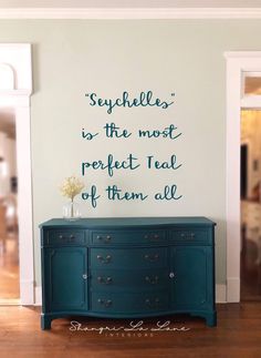 a blue dresser in front of a white wall with a quote on it that says, supple is the most perfect teal of them all