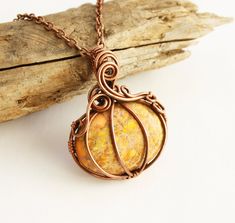 Pumpkin pendant necklace handcrafted from copper wire and a beautiful orange regalite cabochon - you get to choose your stone! (see last photo). Piece will be pre-antiqued and come with an adjustable copper chain that can be fastened anywhere from 18-20 inches with a lobster clasp. Comes gift boxed as shown in last photo, perfectly ready to treat yourself or a special someone! *A note on copper jewelry: If you've never worn copper jewelry before, please be aware that some individuals experience Orange Copper Wire Wrapped Jewelry, Orange Copper Wire Jewelry For Gifts, Orange Copper Wire Jewelry As A Gift, Handmade Yellow Copper Jewelry, Orange Wire Wrapped Handmade Jewelry, Unique Orange Wire Wrapped Jewelry, Thanksgiving Jewelry, Harpers Ferry, Autumn Thanksgiving