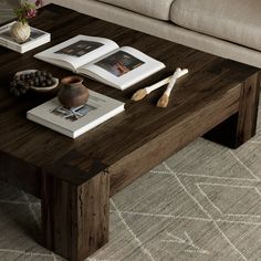 a coffee table with books and other items on it