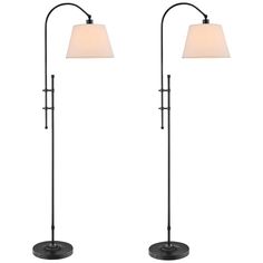 two floor lamps with shades on them