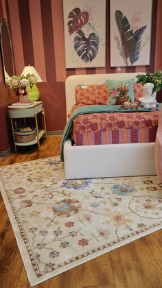 a bed sitting on top of a wooden floor next to a rug