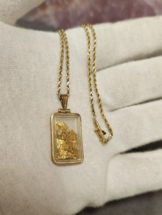 Discover the charm and elegance of our vintage 1.55g 22k raw gold rectangular vial pendant, paired with a delicate 14k gold rope chain, measuring 18 inches in length. This distinctive piece is not only a stunning accessory but also a conversation starter, making it a perfect gift for any special occasion. Features: Gold Content (Pendant): 1.55g 22k Raw Gold Pendant Style: Rectangular Vial Chain Material: 14k Gold Rope Chain, 5.1 grams Chain Length: 18 inches Closure: Slide Latch for secure and e Men’s Gold Chain Pendent, Yellow Gold Necklace With Rectangular Locket Pendant, Yellow Gold Rectangular Amulet Jewelry, Yellow Gold Rectangular Amulet Pendant, Yellow Gold Amulet Necklace With Rectangular Pendant, Rectangular Yellow Gold Amulet Jewelry, Gold Rectangular Pendant Amulet, Rectangular 14k Gold Necklace With Gold Chain, Gold Spiritual Necklace With Rectangular Pendant