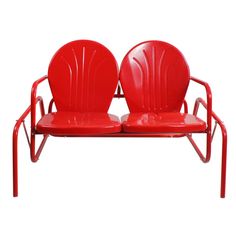 two red chairs sitting next to each other on top of a white surface with no one in it