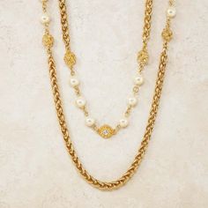 For Sale on 1stDibs - - Vintage item - Measures 94' long - Gold plated - Crystal accents - Faux pearls - By Chanel (signed on hangtag) - Made in France - Circa 1980s - Estate Luxury Gold Double Strand Pearl Necklace, Gold Long Necklace With Pearl Chain For Formal Occasions, Gold Long Necklace With Pearl Chain For Formal Events, Formal Beaded Chain Necklace, Luxury Gold-tone Pearl Chain Necklace, Gold Pearl Long Necklace For Formal Occasions, Luxury Gold Chain Necklace With Pearl Charm, Formal Gold Double Strand Pearl Necklace, Luxury Formal Pearl Necklace With Chain