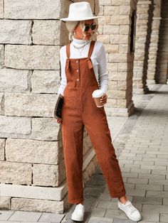 Hop on the overall trend in this Brady Bell Corduroy Overalls in caramel that features a front functional button closure. Size Guide: Gianna is 5’6” tall, and has a 33.5” bust, 24.8”waist, & 37.4” hips. She is wearing a S / US 4 / AU 8. This overall is true to size. Material: 65% Polyester, 35% cotton Feature: Relax fit. Front functional button. On trend. Care Instructions: Machine wash / Cold hand wash Perfect Fall Outfit, Corduroy Overalls, Turtleneck Shirt, Decorative Buttons, Selling Clothes, Type Of Pants, Brown Fashion, Straight Pants, Polished Look