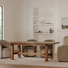 a dining room table and chairs in front of a fireplace with shelves on the wall