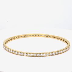 Title: 9.75 Carat Diamond 18 Karat Yellow Gold Bangle Bracelet Style: Bangle Metal: 18 Karat Yellow Gold Gemstone 1: 9.75 Carat Diamond Number of Stones: 65 Color: G Clarity: VS1 Shape: Round Brilliant Dimension: 7-3/4in X 3.5mm Weight: 11.8 Grams Condition: Vintage And Estate Product ID: R21J58 Note: Please note that all the non-GIA Gemstones' Weight, Color, Cut, and Clarity are estimated values to the best of our knowledge. Luxury Tennis Bracelet With Channel Set For Formal Occasions, Luxury Channel Set Tennis Bracelet For Formal Occasions, Luxury Channel Set Diamond Bracelet, Classic Hand Set Yellow Gold Bangle, Yellow Gold Channel Set Diamond Bracelet, Luxury Gold Bracelets With Channel Set, Luxury Gold Channel Set Bracelet, Elegant Formal Channel Set Tennis Bracelet, Timeless Diamond Bracelet With Channel Set For Formal Occasions