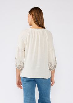 A classic bohemian peasant top is a must-have addition to your spring and summer wardrobe. Featuring an intricate embroidered detail, with a split v-neckline, tassel ties, and exaggerated voluminous 3/4 length sleeves. Try it tucked into denim, or wear it loose over shorts. Linen blend Embroidered Relaxed fit Voluminous 3/4 length long sleeve Elastic cuff Split v-neckline with tassel ties Ruffled neckline Flowy bohemian peasant top Model is 5'9, wearing a size S.Style: I-13851W-RRR Bohemian V-neck Blouse With Tassels, Bohemian V-neck Embroidered Top, Bohemian V-neck Blouse With Embroidered Hem, Folk Style V-neck Blouse With Embroidered Neckline, Spring Folk Style V-neck Peasant Top, Bohemian Embroidered Peasant Top For Fall, Summer Embroidered V-neck Peasant Top, Bohemian Embroidered V-neck Blouse, Bohemian V-neck Rayon Peasant Top