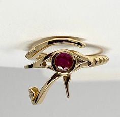 18K gold and Ruby Eye of Ra ring Make a bold statement with this ring that features the eye of Ra a protective symbol said to destroy evil around the wearer in ancient Egyptian culture. Ruby Round Natural Eye-clear Message for pricing in other karats or gemstone customization. Masonic Eye, The Eye Of Ra, Mtv Music Awards, Peacock Ring, Ancient Egyptian Symbols, Mens Skull Rings, Eye Of Ra, Oxidized Silver Rings, Lace Ring