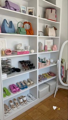 a white bookcase filled with lots of different types of shoes and purses on top of it