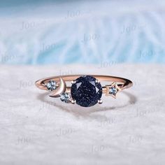 I LOVE YOU TO THE MOON BACK RING 1ct Round Cut Galaxy Starry Night Blue Goldstone Ring Cluster Alexandrite Wedding Ring Moon Star Design Unique Promise Ring Birthday Gifts Accept engrave the words inside the ring service: https://www.etsy.com/listing/1103764936/engrave-service HEALING RING : Blue Sandstone (also known as Blue Goldstone) symbolizes enterprise, success, victory, and glory, which enhance one's leadership and entrepreneurial skills. It is an excellent stone to meditate with before giving a speech or starting a new project. It is also very good at calming the senses and cleansing the chakras on all levels. Blue Sandstone bridges the gap between the earthly and spirit realms, so it is a great stone to use for contacting spirit guides or performing holistic healing. Blue Sandston Blue And Black Ring, Night Sky Jewelry, Moon Promise Ring, Space Themed Engagement Ring, Galaxy Ring Engagement, Starry Engagement Ring, Moon Ring Design, Celestial Crystal Ring For Anniversary, Starry Night Ring