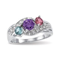 three stone ring with diamond accents and two colored stones on each band, set in white gold