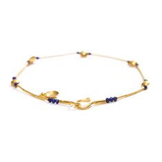 24K yellow gold, lapis lazuli beads 0.90cts total weight Preserving a piece of history from Ancient Anatolia, Fatih translates the master craftsmanship of prehistoric eminence into contemporary works of art. As show with: Gold and Emerald Bracelet, Gold and Ruby Bracelet, and Gold and Sapphire Bracelet. • 7.75" (19.69cm) length • 0.17" (0.43cm) maximum width • Hook and eye clasp Gold Bracelets With Lapis Lazuli And Natural Stones, Hand-strung Gold Lapis Lazuli Bracelets, Gold Lapis Lazuli Bracelet With Gemstone, Gold Lapis Lazuli Gemstone Bracelet, Gold Lapis Lazuli Spiritual Bracelets, Gold Lapis Lazuli Jewelry With Polished Beads, Traditional Gold Jewelry With Lapis Lazuli, Traditional Gold Lapis Lazuli Jewelry, Emerald Bracelet Gold