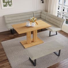 a living room with a couch, table and two benches in front of a window