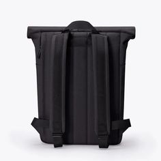 the back view of a black backpack on a white background with no one in it