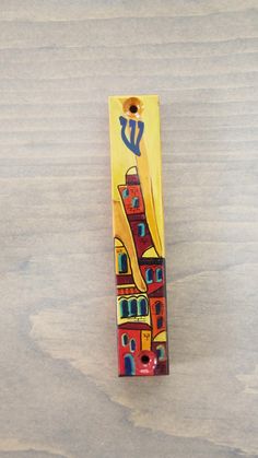 a yellow bookmark with an image of a city on it