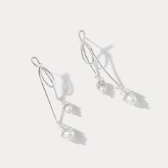 Elevate your elegance with our Silver Lily Of The Valley Bow Earrings. Crafted in sterling silver, these delicate earrings showcase the iconic Lily of the Valley motif in a charming bow design. A touch of femininity and nature-inspired grace, these earrings are perfect for adding a subtle yet timeless accent to your look.  🎀 DETAILS Materials:  Sterling  Silver, Pearl Size: 2.09"* 0.31 "(5.3cm*0.8cm) Weight: 7.4g/pr Elegant Silver Dangle Wrap Earrings, Delicate Sterling Silver Pearl Earrings, Sterling Silver Drop Earrings For Party, Dainty Silver Drop Wrap Earrings, Sterling Silver Drop Wrap Earrings For Party, Sterling Silver Wrap Drop Earrings For Party, Formal Silver Sterling Silver Wrap Earrings, Silver Drop Earrings For Wedding, Elegant Silver Wrap Earrings For Party