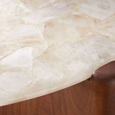 a piece of white marble on top of a wooden table