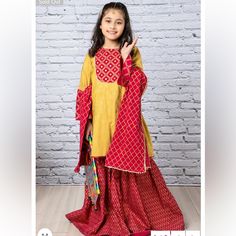 Gold Printed Shirt With Sheesha Embellishment Paired With Printed Gharara. 3 Piece Set. Comes With Kameez, Gharara And Potluck Cloth Bag. Brand New With Tags. Indian Pakistani Kids Designer Out. Size 4-5t. Mirror Work Embellishments. Yellow Palazzo Set With Dabka For Navratri, Yellow Dabka Palazzo Set For Navratri, Navratri Yellow Dabka Palazzo Set, Yellow Dabka Palazzo Set For Festivals, Yellow Palazzo Set With Dabka For Festivals, Yellow Palazzo Set With Dabka For Diwali, Festive Yellow Palazzo Set With Long Sleeves, Yellow Long Sleeve Palazzo Set For Festive Occasions, Festive Yellow Palazzo Set With Dabka Detailing