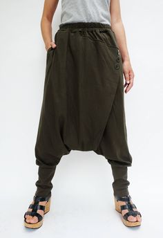 "🚚..ALL ORDERS ARE SHIPPED VIA DHL EXPRESS MAIL Relaxed fit dropped-crotch pants in olive. Asymmetric crossover fabric panel at front and back with 3 buttons front detailed. Elastic waistband and two hand pockets at side seam. Roll up the cuffed hem for an utlra relaxed look! * Pull-on style * Drop-crotch style * 2\" Elastic waistband * Side seam pockets * Wide cuffed hem Measurements approximately: Waist : 26\" (66 cm) stretching to 48\" (122 cm)-elastic material Hips : 50\" (122 cm) Outseam: Sarouel Pants, Muslim Pictures, Unisex Pants, Drop Crotch Pants, Ancient Times, Fabric Panels, Button Detail, Harem Pants, Cover Up