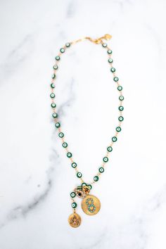 Worn alone or layered with your personal favorites, the Galia Necklace wards off evil gazes and looks with its collection of green evil eyes. Finished with a collection of golden charms the Galia is easily thrown on to polish your look. Premium Austrian & Czech Crystals, Glass Stones, 24kt Gold Plate, Proudly Made Gold Plated Green Necklace With Jewels, Gold Agate Necklace With Colorful Beads, Elegant Green Gemstone Charm Necklace, Gold-plated Green Jeweled Necklaces, Luxury Green Agate Beaded Necklace, Glamorous Jewelry, Elizabeth Cole, Free Earrings, Czech Crystal