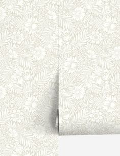 a white wallpaper with an intricate design on it's side and the bottom half