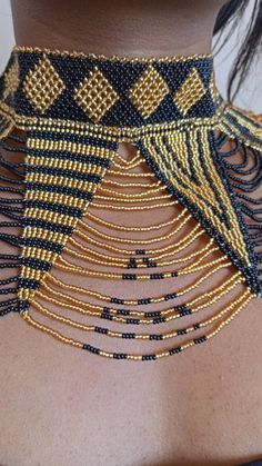 African wedding necklace, Zulu necklace, Beaded shawl necklace, African jewelry, Masai necklace, Bridesmaid necklace, Wedding gift This stunning necklace is superbly crafted with fine beads. The necklace can be worn with any outfit at different occasions and it will absolutely makes you stand out. 100% handmade using fine beads. Closure: ball joint Color: gold and black. 3-5 days delivery via DHL Express The shipping fee is for the first item only and additional necklaces or items ship for free. Bohemian Beaded Pearl Necklace For Weddings, Elegant Festival Beaded Necklaces With Gold Beads, Unique Gold Beaded Choker, Elegant Gold Beaded Festival Necklaces, Party Necklaces With Tiny Round Beads, Party Necklace With Tiny Round Beads, Traditional Tiny Beads Choker Necklace, Adjustable Gold Beaded Necklaces With Bead Caps, Bohemian Beaded Bib Necklace For Wedding