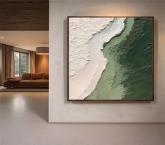 an abstract painting hangs on the wall next to a couch