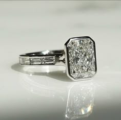 a diamond ring sitting on top of a table