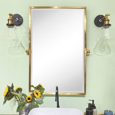 a bathroom sink sitting under a mirror next to a faucet and soap dispenser