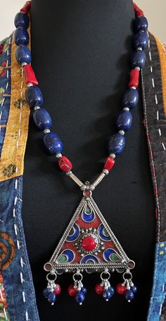 Artisan Red Jewelry With Inlay, Artisan Red Inlay Jewelry, Red Bohemian Necklace With Large Pendant, Traditional Red Coral Jewelry With Polished Beads, Traditional Red Gemstone Necklaces, Artisan Red Ceremonial Necklaces, Artisan Red Necklaces For Ceremonial Occasions, Bohemian Red Coral Necklace For Gift, Artisan Red Necklaces For Ceremonial Use