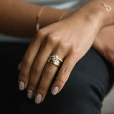 a close up of a person's hand with a ring on their finger