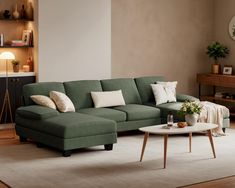 a living room with a green couch and coffee table in front of a wall mounted clock