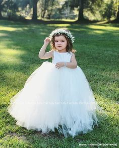 "Sweet simplicity! Our unique full and fluffy tulle dress feature a lined ivory satin sleeveless bodice with an ivory tutu style skirt. The back of the dress bodice is stretchy for a custom, yet versatile, comfort fit. Pictured in a SOLID IVORY dress. Select from the dropdown if you would like an IVORY dress (as pictured), or a SOLID WHITE or SOLID OFF-WHITE (LIGHT IVORY) dress instead. We can change these colors! Video shows light ivory on the left and ivory on the right WANT A SEWN IN SLIP TO Tulle Flower Girl Dress, Toddler Flower Girls, Dress Bodice, White Tutu, Fluffy Skirt, Ivory Flower Girl Dresses, Girls Tutu Dresses, Flower Girl Dresses Tutu, Toddler Flower Girl Dresses