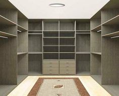 an empty walk in closet with shelves and drawers on each side, carpeted floor