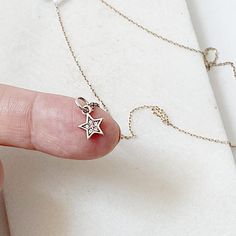 1/4” tiny star charms sterling silver with little cubic zirconia gems set inside. 16” chain. Perfect for layering! Sterling Silver Star Necklace With Diamond Accents, Silver Star Charm For Everyday, Sterling Silver Star Jewelry For Everyday, Everyday Sterling Silver Star Jewelry, Dainty Star-shaped Charms Jewelry, Dainty Star Shaped Charms Jewelry, Dainty Star-shaped Charm Necklace, Dainty Cubic Zirconia Jewelry With Star Charm, Dainty White Gold Charm Necklaces With Diamond Accents