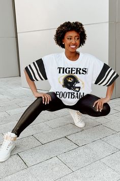 Show off your school or team spirit with our bold contrast sporty oversized short sleeve tee. Featuring trendy jersey mesh sleeves with sports striping, a ribbed neckline, and 100% cotton, it'll be easier than ever to represent in style. Sporty Oversized T-shirt For Game Day, Varsity Tops For Cheerleading During Football Season, Collegiate Tops With Team Logo For Cheerleading, Sporty T-shirt With Team Logo For Cheerleading, Collegiate White Top For Football Season, White Collegiate Top For Football Season, Cheerleading Team Logo Short Sleeve Tops, Short Sleeve Tops With Team Logo For Cheerleading, College Style Short Sleeve Tops For Game Day